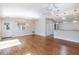 Bright living room features wood floors, ceiling fan, and modern pendant lighting at 1667 Osprey Ave, The Villages, FL 32162