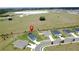 Aerial view of a neighborhood and home featuring a pin marker with fields in the background at 1688 Littleleaf Boxwood Loop, Mascotte, FL 34753
