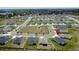 A residential neighborhood with modern homes and green lawns, featuring a central green space for outdoor activities, community water access at 1688 Littleleaf Boxwood Loop, Mascotte, FL 34753