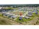 New residential construction neighborhood with modern single-Gathering homes and green lawns, close to a playground and community water tower at 1688 Littleleaf Boxwood Loop, Mascotte, FL 34753