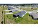 Aerial view of a landscaped home in a community near a street, showcasing backyard at 1688 Littleleaf Boxwood Loop, Mascotte, FL 34753