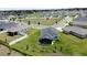 Aerial view of a home with a screened-in patio and a view of surrounding neighborhood at 1688 Littleleaf Boxwood Loop, Mascotte, FL 34753