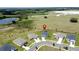 Suburban home on a large lot with lush green lawns, surrounded by a serene landscape of ponds and verdant fields at 1688 Littleleaf Boxwood Loop, Mascotte, FL 34753