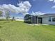 Expansive backyard with a screened lanai, lush green grass, and a fenced perimeter at 1688 Littleleaf Boxwood Loop, Mascotte, FL 34753