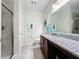 Bathroom with modern vanity, granite counters, enclosed glass shower, and tile flooring at 1688 Littleleaf Boxwood Loop, Mascotte, FL 34753