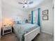 Comfortable bedroom with light colored carpet, decorated with blue accents and coastal artwork at 1688 Littleleaf Boxwood Loop, Mascotte, FL 34753