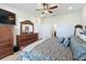 Spacious bedroom featuring a dark wood dresser with ample storage and plush carpet flooring at 1688 Littleleaf Boxwood Loop, Mascotte, FL 34753