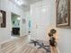 Welcoming entryway with a decorative rug, leading to a bathroom and bedroom at 1688 Littleleaf Boxwood Loop, Mascotte, FL 34753