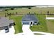Well-maintained single-Gathering home with a long driveway and manicured lawn in a suburban neighborhood at 1688 Littleleaf Boxwood Loop, Mascotte, FL 34753