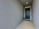 Inviting front door with elegant wreath and textured walls in a welcoming entryway at 1688 Littleleaf Boxwood Loop, Mascotte, FL 34753