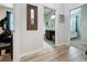 Hallway view leading to a bathroom and bedroom featuring hard wood floors at 1688 Littleleaf Boxwood Loop, Mascotte, FL 34753