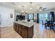 Spacious kitchen island with bar seating and view of living area with outside access at 1688 Littleleaf Boxwood Loop, Mascotte, FL 34753