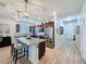 Modern kitchen with granite countertops, stainless steel appliances, and a breakfast bar with pendant lighting at 1688 Littleleaf Boxwood Loop, Mascotte, FL 34753
