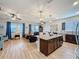 Open-concept kitchen and living area with modern appliances and stylish decor at 1688 Littleleaf Boxwood Loop, Mascotte, FL 34753