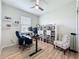 Home office with natural light, adjustable desk, shelving, and comfortable seating at 1688 Littleleaf Boxwood Loop, Mascotte, FL 34753