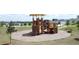 Community playground featuring play equipment with a wood chip base and neighborhood views at 1688 Littleleaf Boxwood Loop, Mascotte, FL 34753