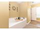 Relaxing bathroom showcasing a soaking tub with caddy and decorative fixtures, ideal for unwinding at 1704 Hoofprint Court, Fruitland Park, FL 34731