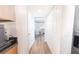 Hallway featuring hardwood flooring, white walls, and natural lighting, creating a clean and inviting space at 1704 Hoofprint Court, Fruitland Park, FL 34731