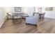 Inviting living room with wood floors, stylish grey seating, and view of adjacent dining area at 1704 Hoofprint Court, Fruitland Park, FL 34731