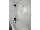Close up of bathtub and shower with black fixtures and marble look tiling at 17459 Sw 17Th Cir, Ocala, FL 34473