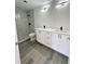 Contemporary bathroom featuring double vanity, modern lighting and walk-in shower with black fixtures at 17459 Sw 17Th Cir, Ocala, FL 34473