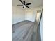 Bright bedroom with a ceiling fan, closet and attractive gray vinyl floors at 17459 Sw 17Th Cir, Ocala, FL 34473