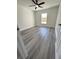 Bedroom with grey wood flooring, a ceiling fan, and a window letting in natural light at 17459 Sw 17Th Cir, Ocala, FL 34473