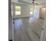 Spacious bedroom with a closet, two windows, tray ceiling, and vinyl floors at 17459 Sw 17Th Cir, Ocala, FL 34473