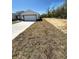 New home featuring a large front yard and spacious driveway leading to the garage at 17459 Sw 17Th Cir, Ocala, FL 34473