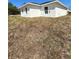 Side view of a newly constructed, bright white house with a few windows, contrasted against a backdrop of natural grass at 17459 Sw 17Th Cir, Ocala, FL 34473
