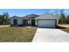 Charming single-story home featuring a well-manicured lawn and a spacious two-car garage at 17459 Sw 17Th Cir, Ocala, FL 34473