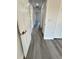 Hallway featuring gray wood flooring and white walls and doors at 17459 Sw 17Th Cir, Ocala, FL 34473
