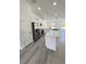 Open concept kitchen with modern white cabinets and stainless steel appliances at 17459 Sw 17Th Cir, Ocala, FL 34473