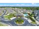 Aerial view of a clubhouse, pool, and beautiful landscaping at 17519 Promenade Dr, Clermont, FL 34711