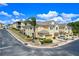 Street view showcasing a two-story townhome with a private garage and manicured lawn at 17519 Promenade Dr, Clermont, FL 34711