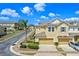 Exterior view of a two-story townhome with a driveway and lush landscaping at 17519 Promenade Dr, Clermont, FL 34711