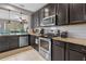 This well-appointed kitchen features stainless steel appliances, granite countertops and dark wood cabinets at 17519 Promenade Dr, Clermont, FL 34711