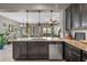 An open-concept kitchen featuring an eat-in island with granite countertops and stainless steel appliances at 17519 Promenade Dr, Clermont, FL 34711