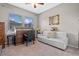 Bright home office with roll-top desk and comfortable seating at 17519 Promenade Dr, Clermont, FL 34711