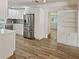 Bright kitchen featuring white cabinetry, stainless steel appliances, and wood look flooring at 1765 Hilltop Dr, Mount Dora, FL 32757