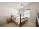 Bedroom features a four-poster bed, ceiling fan, and large window with natural light at 1833 Endsley Ct, The Villages, FL 32162