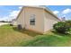Beige siding exterior with green grass and blue sky at 1833 Endsley Ct, The Villages, FL 32162