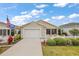 Charming home with a well-manicured lawn and a welcoming front entrance and attached garage at 1833 Endsley Ct, The Villages, FL 32162