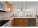 Galley kitchen features wood cabinets, white countertops, and a stainless steel dishwasher at 1833 Endsley Ct, The Villages, FL 32162