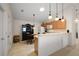 Bright kitchen featuring wood cabinets, white appliances, tile floor, and hanging pendant lights at 1833 Endsley Ct, The Villages, FL 32162
