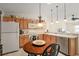 Kitchen with wood cabinets, stainless steel appliances, and open counter space at 1833 Endsley Ct, The Villages, FL 32162
