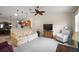 Bright and open living room featuring a floral sofa, white armchair, and connecting kitchen area at 1833 Endsley Ct, The Villages, FL 32162
