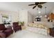 Open-concept living room with neutral carpet, floral sofa, comfortable seating, and dining area at 1833 Endsley Ct, The Villages, FL 32162