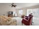 Spacious living room with neutral carpet, floral sofa, comfortable chairs and large windows at 1833 Endsley Ct, The Villages, FL 32162