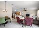 Open-concept living room with neutral carpet, comfortable seating, dining area, and connecting kitchen at 1833 Endsley Ct, The Villages, FL 32162